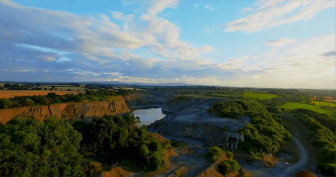 scenic view of quarry with lush greenery and calm waters at sunset - Download Free Stock Videos Pikwizard.com