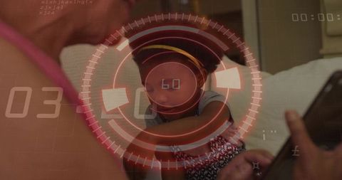 Grandmother cradling granddaughter while using tablet with red hud overlay, tech bonding