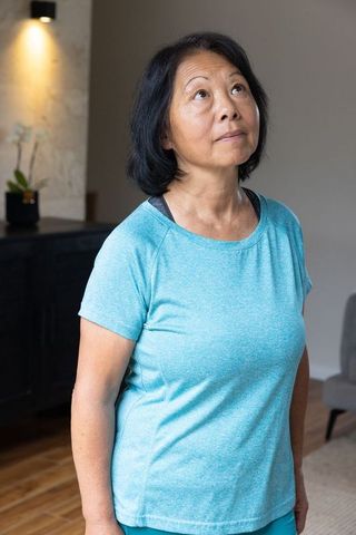 Thoughtful Asian Woman in Serene Minimalist Living Space