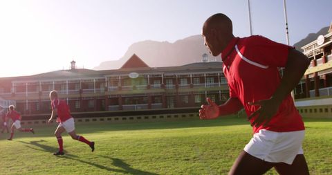 School rugby team practicing on field during sunny day