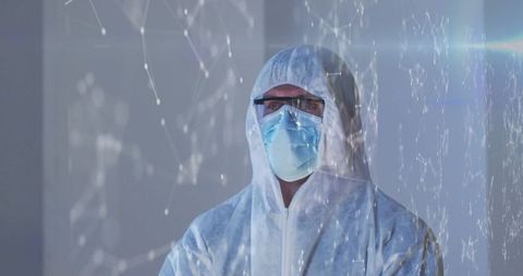 Scientist wearing full ppe n95 mask and goggles with futuristic network overlay