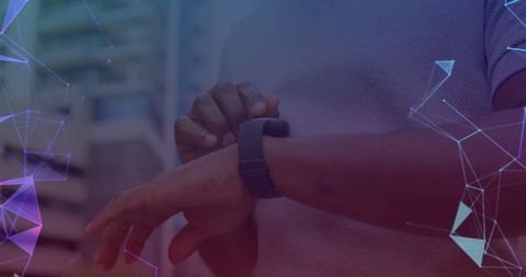 Man Interacting with Smartwatch Illuminated by Abstract Network Patterns