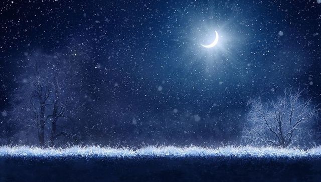 Glowing crescent moon casting halo over frosty meadow, falling snow and leafless trees