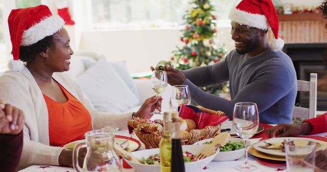 Family Celebrating Christmas with Festive Meal and Santa Hats - Download Free Stock Images Pikwizard.com