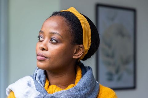 African american woman gazing left wearing mustard headband and gray scarf