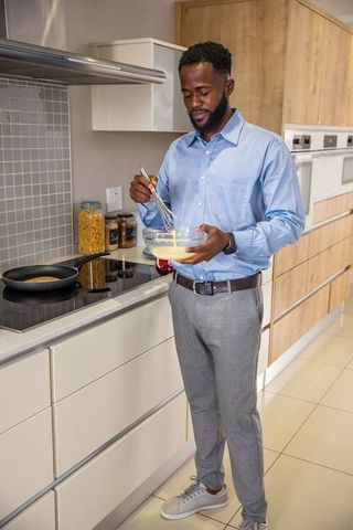 African American Man Whisking Batter Modern Home Kitchen