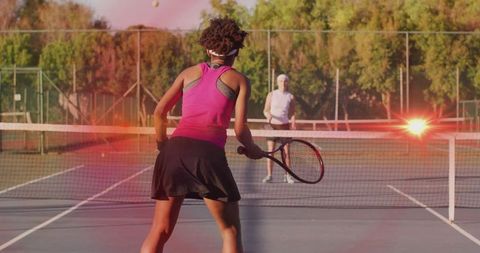 Dynamic Tennis Match with Athletes on Sunlit Court