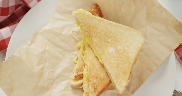 Image of freshly prepared cheese white bread sandwich on paper and white plate - Download Free Stock Photos Pikwizard.com