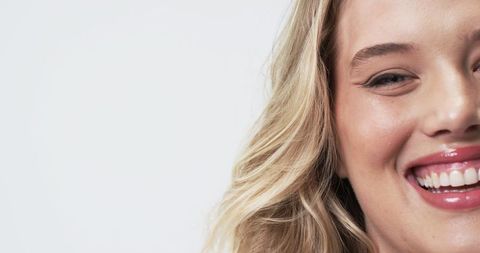 Confident Plus Size Woman Smiling with Joy in Bright Studio