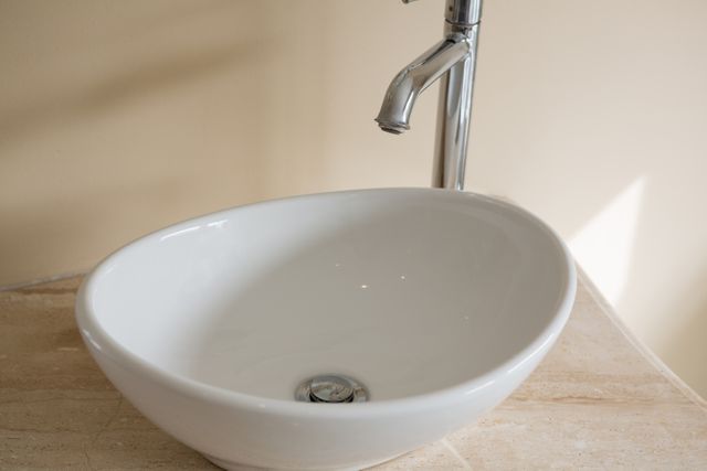 Close-up of faucet and sink in bathroom at home