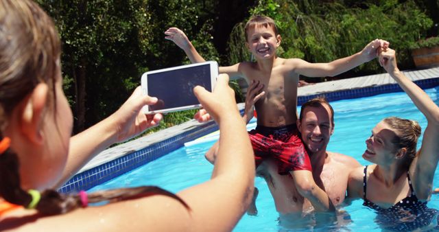 Happy Family Taking Photos in Swimming Pool on Sunny Day - Download Free Stock Images Pikwizard.com