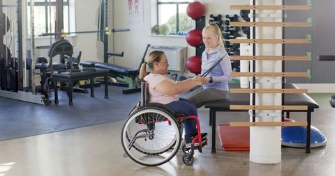 Physical Therapy for Woman in Wheelchair in Rehabilitation Center