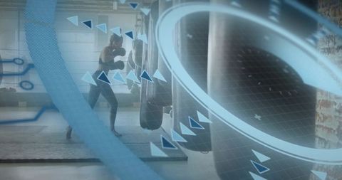 Female boxer training with futuristic digital hud overlay hitting heavy bag in gym