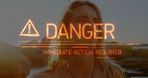 Danger alert warning by the rocky coast at sunset