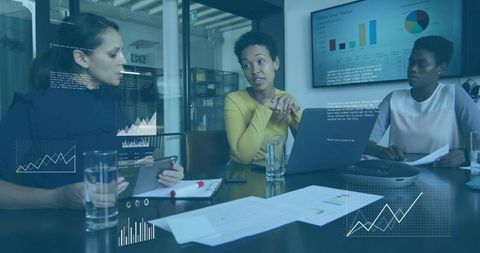 Three Women Collaborating Around Laptop Reviewing Analytics, Sales Charts and Team Metrics