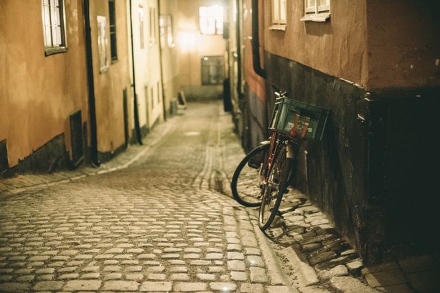 Vintage Bicycle Leaning Against Old Cobbled Street at Night - Download Free Stock Photos Pikwizard.com