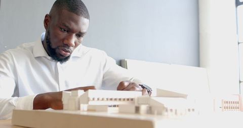 Architect Focusing on Detailed Building Model Design - Download Free Stock Images Pikwizard.com