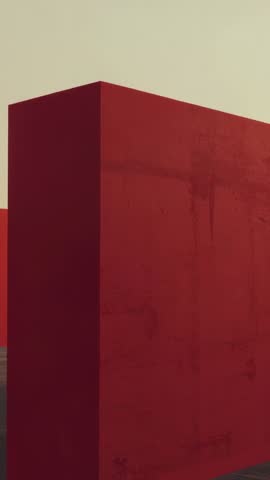 Vertical moving camera translating toward tall red monolith in empty plaza revealing stains