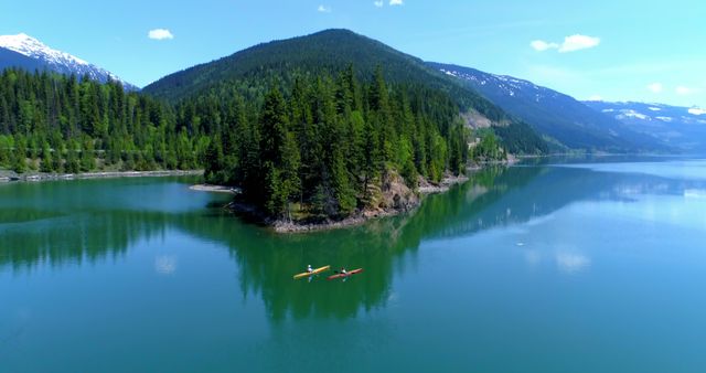 A person kayaks in a tranquil mountain lake, surrounded by lush forests, with copy space. Kayaking in such a serene environment offers a peaceful escape and a chance to connect with nature.