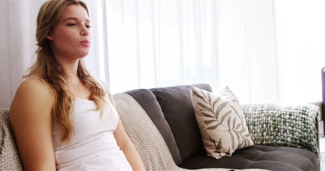 Young Woman Relaxing on Couch in Cozy Home - Download Free Stock Images Pikwizard.com