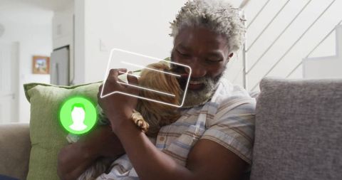 Smiling senior man relaxing with dog at home symbolizing connection and comfort