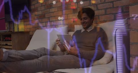 male entrepreneur analyzing stock data on tablet at home - Download Free Stock Images Pikwizard.com
