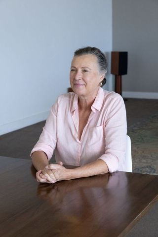 Elegant senior woman relaxing in contemporary minimalist interior