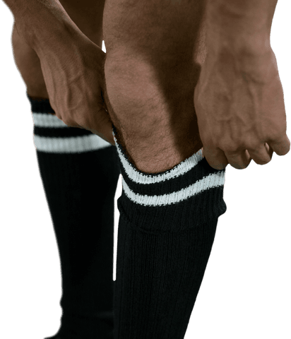 Transparent view of athlete adjusting football socks with focus