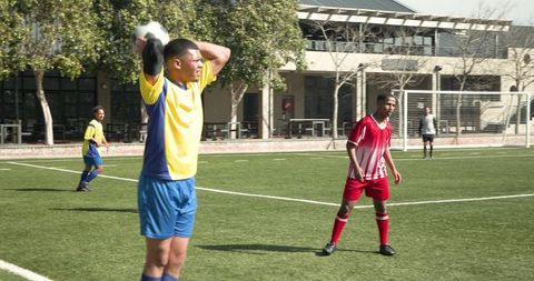 Young soccer players competing intensely on busy field