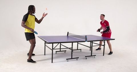 Diverse table tennis players engaging in intense rally