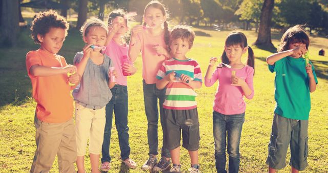 Happy children blowing bubbles in sunny park - Download Free Stock Images Pikwizard.com