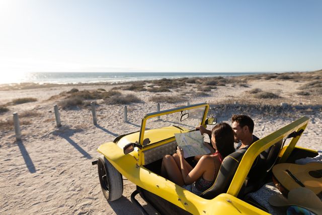 Couple sitting in a yellow beach buggy on a sunny beach, looking at a map and talking. Ideal for travel blogs, vacation advertisements, romantic getaway promotions, and lifestyle magazines. Perfect for illustrating themes of adventure, exploration, and leisure.