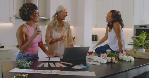 Diverse group of women planning wedding in modern kitchen