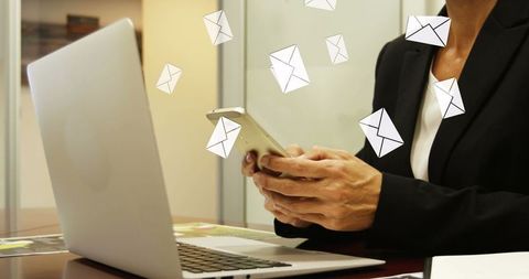 Businesswoman Engaging in Digital Communication with Envelopes Floating