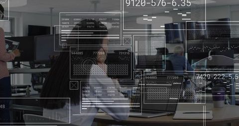 Woman typing on laptop in modern open-plan office with holographic HUD data overlays