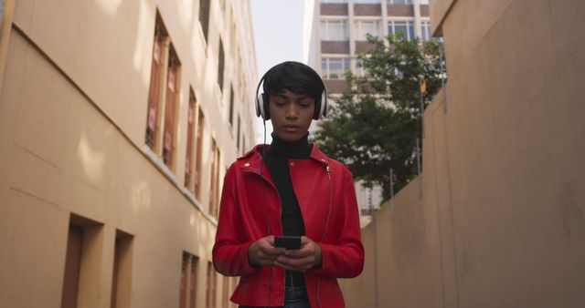 Young Woman in Red Jacket Listening to Music While Using Smartphone - Download Free Stock Images Pikwizard.com