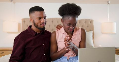 Couple Enjoying Leisure Time with Laptop in Living Room