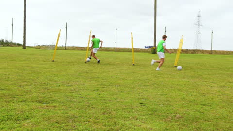 Soccer Players Practicing Dribbling Skills on Training Field