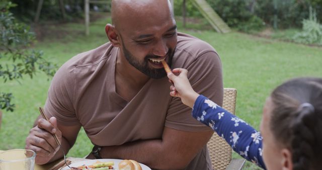 Delighted Father Enjoying Meal with Daughter in Garden - Download Free Stock Images Pikwizard.com