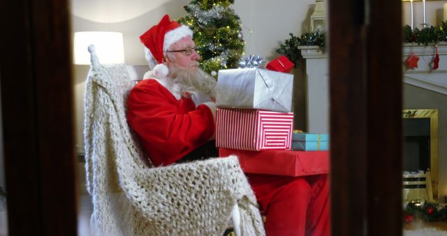 Santa Claus Unboxing Christmas Gifts Near Festive Fireplace - Download Free Stock Images Pikwizard.com