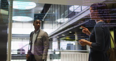 Colleagues Analyzing Program Code Display in Modern Workplace