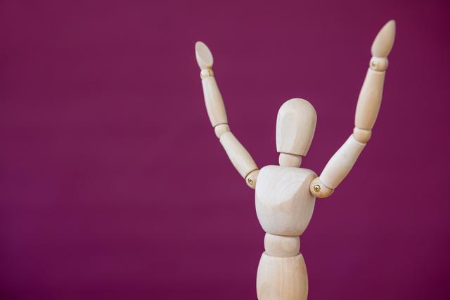 Conceptual image of figurine standing with arms outstretched