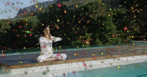 Teen meditating on pool deck with colorful radial light burst outdoors for mindfulness
