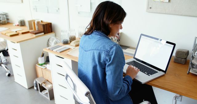 Woman Working on Laptop in Design Office - Download Free Stock Images Pikwizard.com