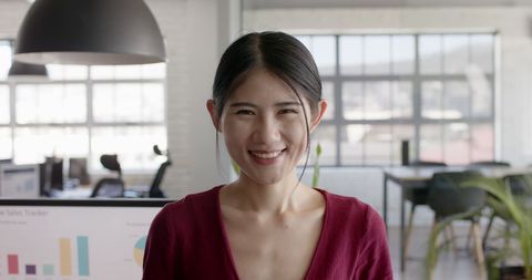 Smiling Asian Businesswoman in Modern Office Interior
