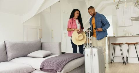 Couple Packing for Vacation with Suitcase at Home