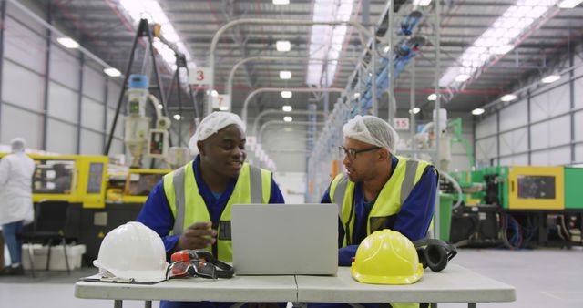 Industrial Engineers Discussing Work at Laptop in Manufacturing Factory - Download Free Stock Images Pikwizard.com