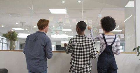 Team brainstorming with sticky notes for workflow mapping