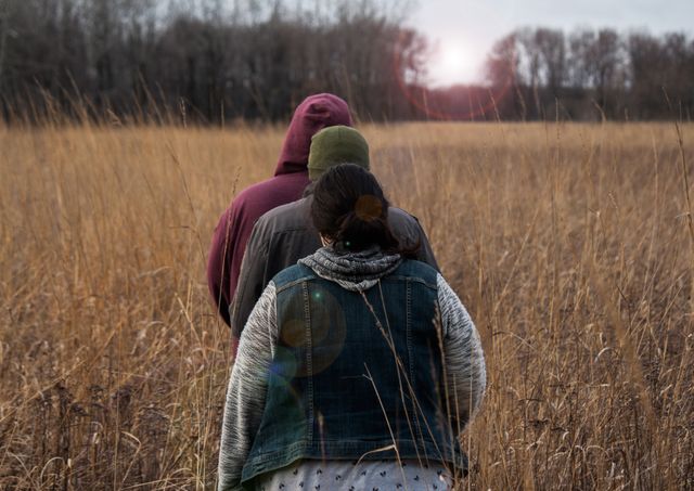 Hikers Wandering Through Tall Autumn Grass at Sunset - Download Free Stock Images Pikwizard.com