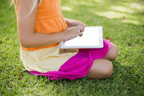 Girl in Colorful Dress Sitting Grass Using Transparent Tablet - Download Free Stock Videos Pikwizard.com